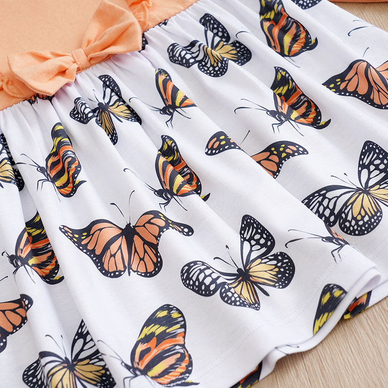 Baby Butterfly Dress Long Sleeve | Hushies Boutique showing butterfly print skirt with soft peach bow and gathered waist detail