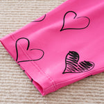 Adorable Little Lovebug Baby Girl Clothing Set - Soft Cotton Outfit for Infants with black heart print on bright pink fabric sleeve hem
