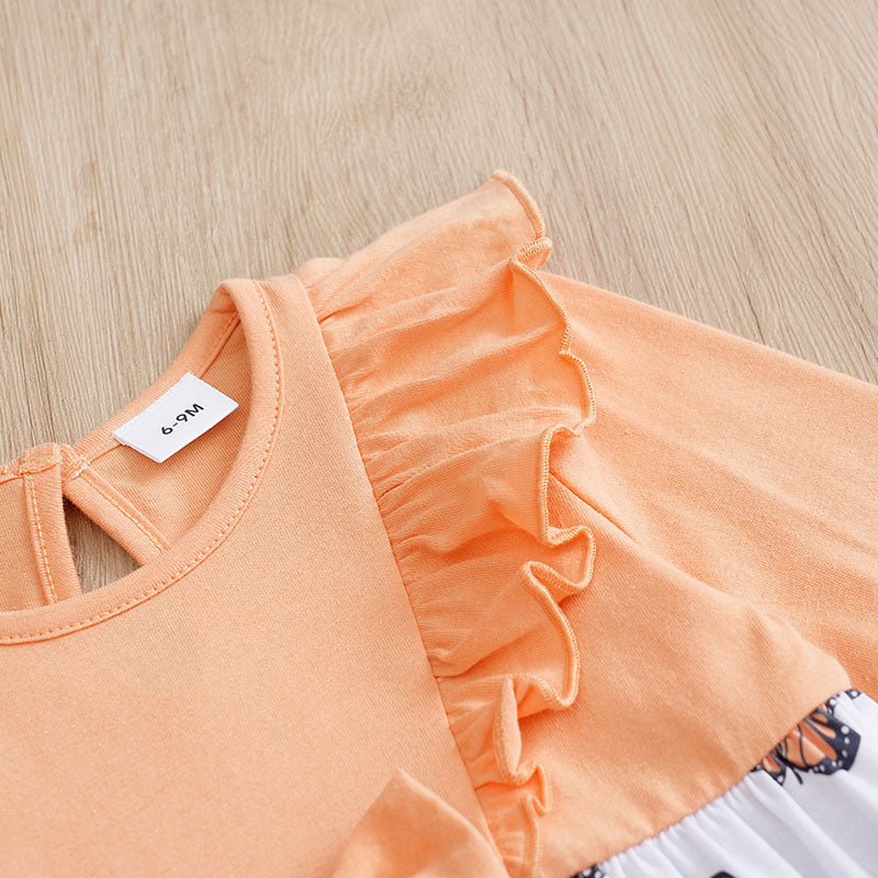 Baby Butterfly Dress Long Sleeve | Hushies Boutique showing peach fabric with delicate ruffled detail on soft infant clothing