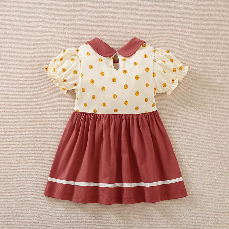 A cream and maroon polka dot toddler dress with a collar and white stripes.