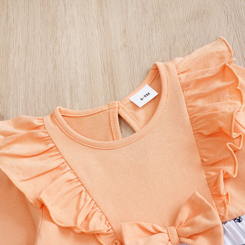 Baby Butterfly Dress Long Sleeve | Hushies Boutique showing peach fabric with ruffled shoulder detail and bow accent on soft baby clothing