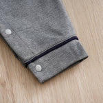 Baby Boy Cotton Gentleman Outfit - Soft, Stylish, Eco-Friendly Jumpsuit with Classic Design showing cuff and snap button on gray fabric