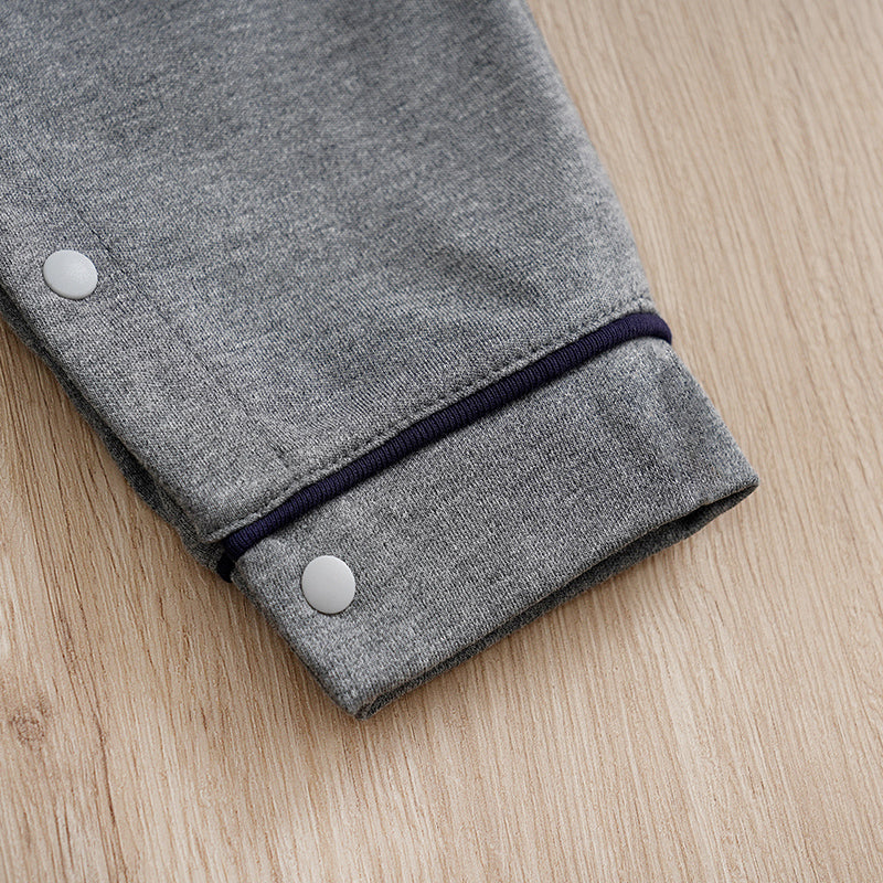Baby Boy Cotton Gentleman Outfit - Soft, Stylish, Eco-Friendly Jumpsuit with Classic Design showing cuff and snap button on gray fabric