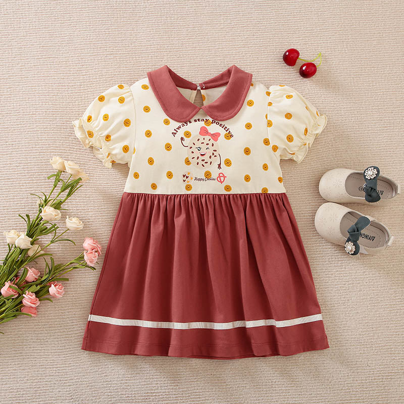 Off-white and reddish-brown polka dot toddler dress with a collar and puffed sleeves.