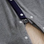 Baby Boy Cotton Gentleman Outfit - Soft, Stylish, Eco-Friendly Jumpsuit with Classic Design showing snap button closure detail on gray fabric