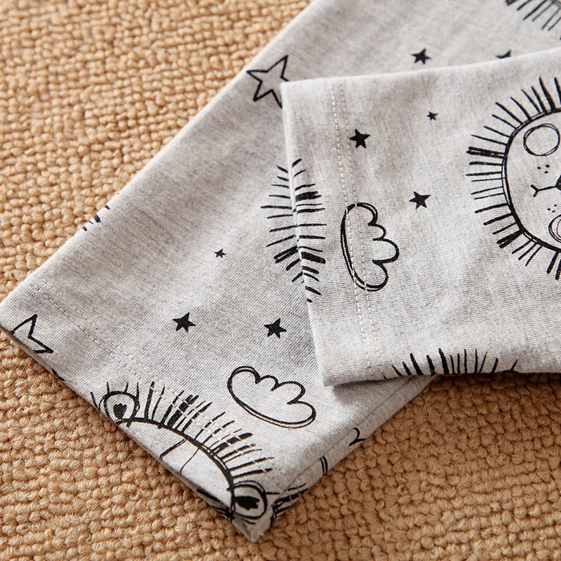 Gray fabric with black line art patterns on a beige surface