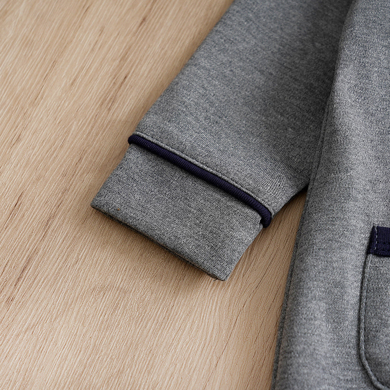 Baby Boy Cotton Gentleman Outfit - Soft, Stylish, Eco-Friendly Jumpsuit with Classic Design sleeve cuff and navy trim detail on wooden background