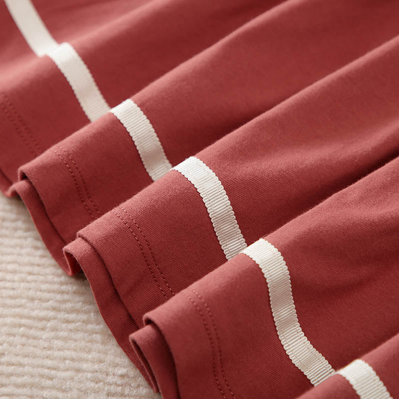 Soft rust-colored cotton fabric with white ribbed stripes folded.