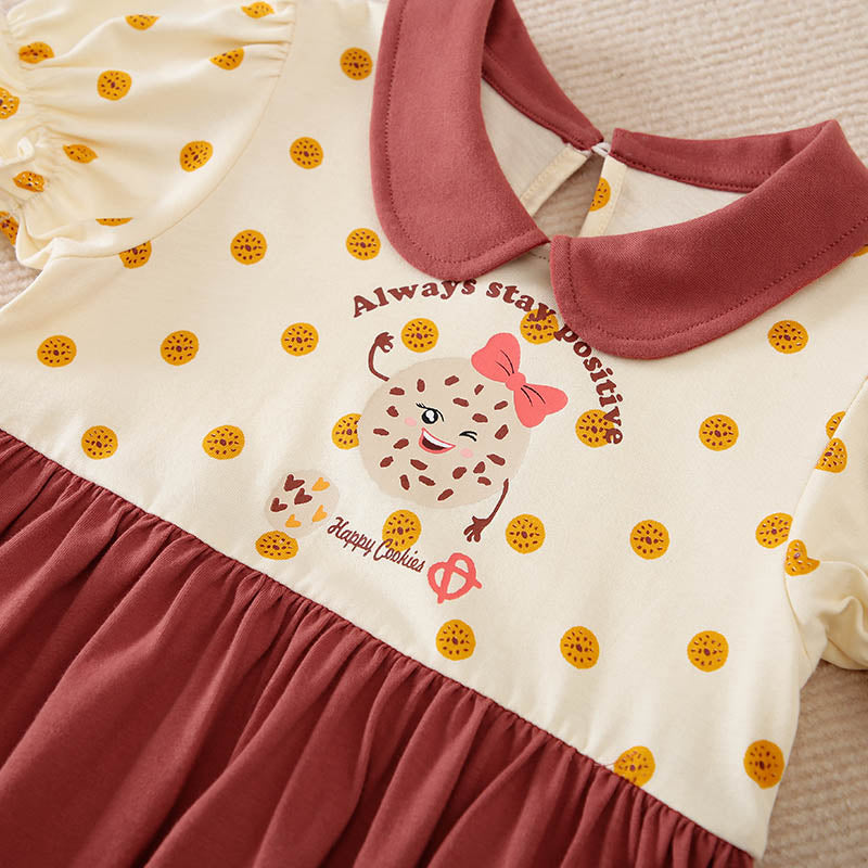 Soft cotton toddler dress with reddish-brown collar, polka dots, and a cookie graphic.