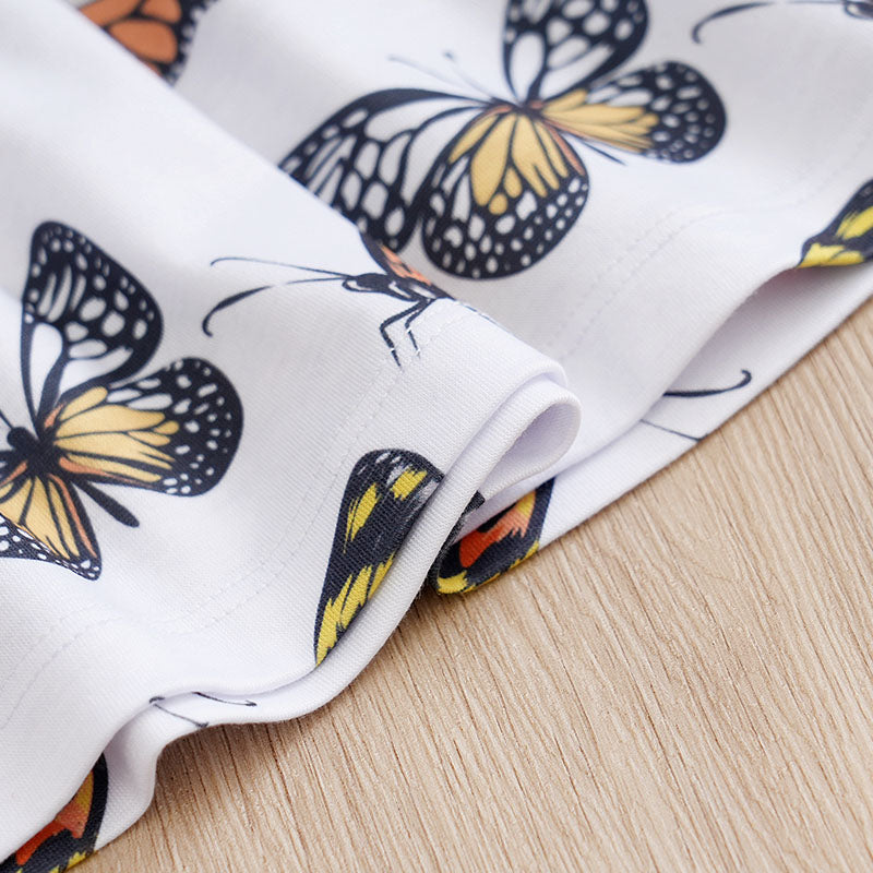 Baby Butterfly Dress Long Sleeve | Hushies Boutique showing close-up of butterfly print detail on soft white infant clothing fabric