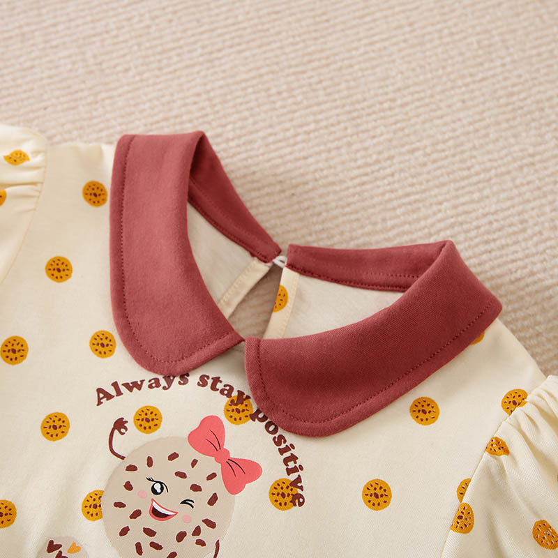 Cream toddler top with reddish-brown collar, cookie polka dots, and winking cookie graphic.