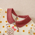 Cream toddler top with reddish-brown collar, cookie polka dots, and winking cookie graphic.
