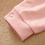 Unicorn Baby Jumpsuit Pink Romper | Hushies Soft Bow close-up of cuff with snap button on soft pink infant romper fabric