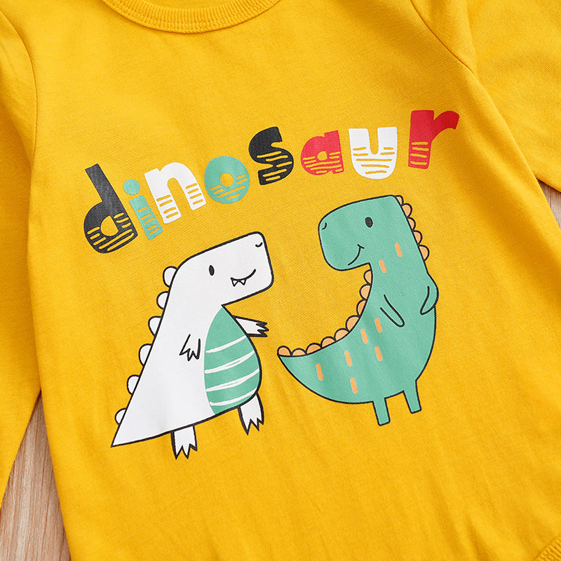 Yellow shirt with cartoon dinosaurs and the word 'dinosaur' on a wooden surface