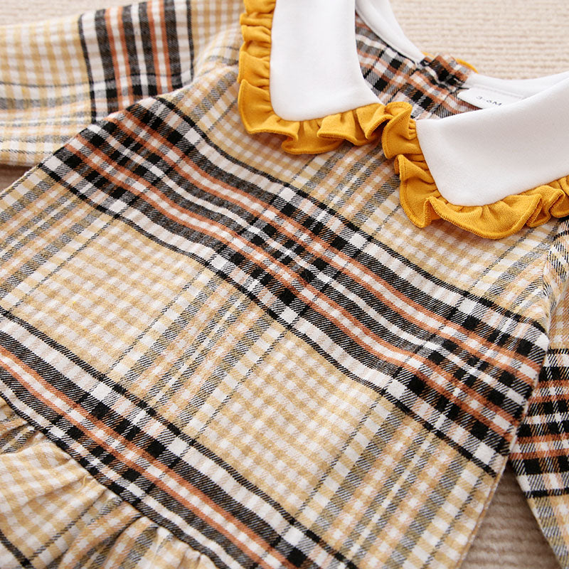 Plaid dress shirt with yellow ruffled trim on a neutral background