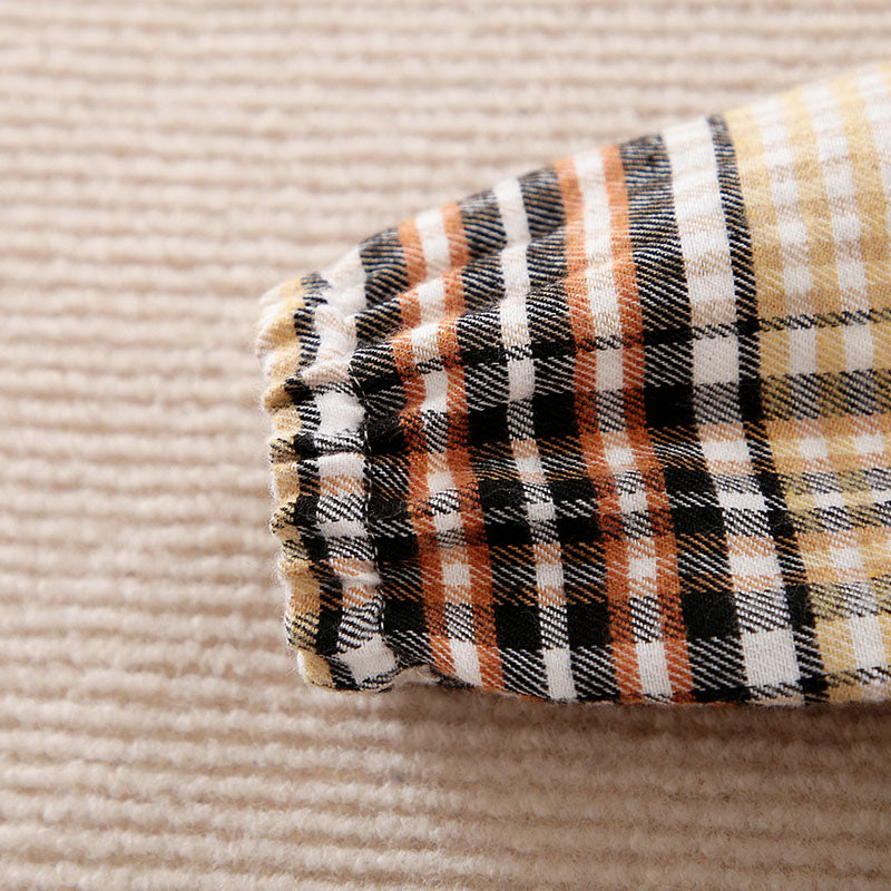 Plaid patterned sleeve on a textured beige background