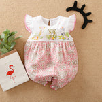Baby romper with animal prints on a beige background