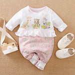 Cute white and pink baby jumpsuit featuring cartoon safari animals and heart print.