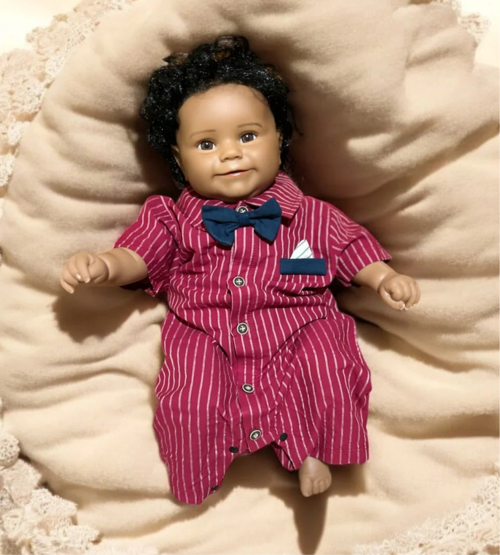 Charming baby doll in a red striped shirt and bow tie, representing the essence of a fashionable little gentleman.