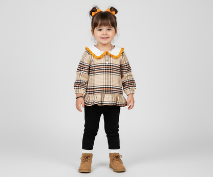 Adorable toddler girl wearing a stylish plaid shirt with frilled collar and long sleeves, showcasing her playful look in a comfy outfit, perfect for any occasion.