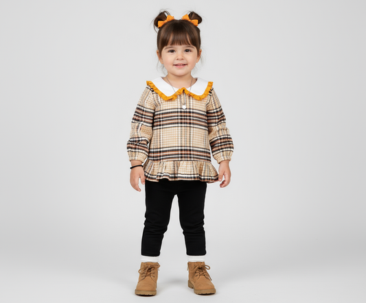 Adorable toddler girl wearing a stylish plaid shirt with frilled collar and long sleeves, showcasing her playful look in a comfy outfit, perfect for any occasion.