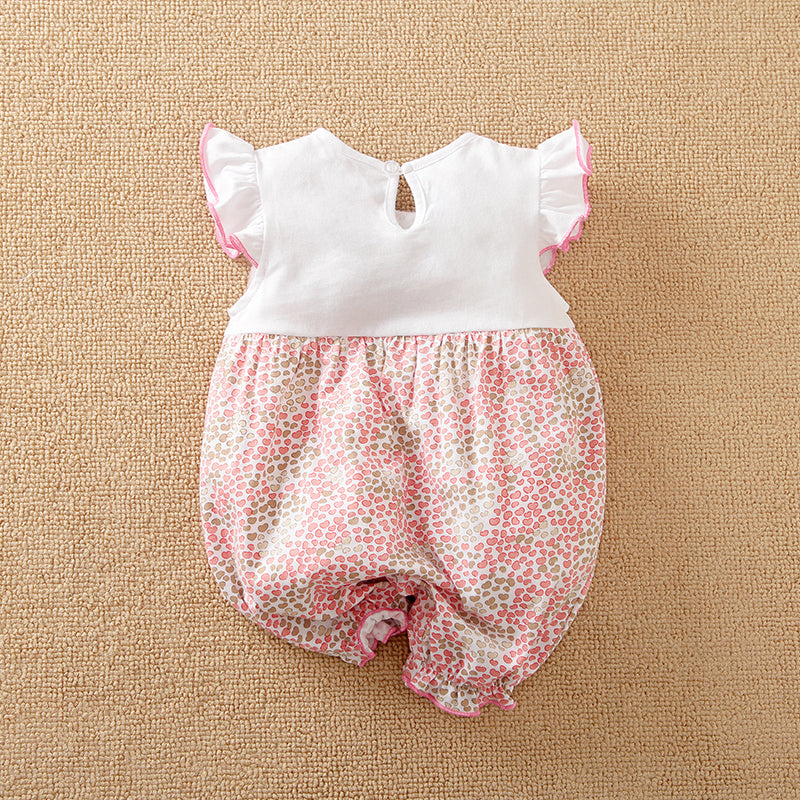 Baby romper with white top and pink floral bloomers on the bottom half on a beige background