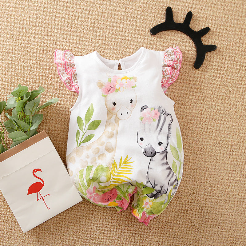 The Adorable 1-Piece Deer & Zebra Print Baby Romper with ruffle sleeves lies on a woven surface, next to a paper bag with a flamingo and a black antler headband.