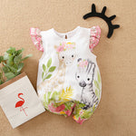 The Adorable 1-Piece Deer & Zebra Print Baby Romper with ruffle sleeves lies on a woven surface, next to a paper bag with a flamingo and a black antler headband.