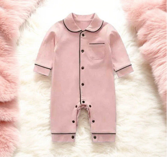 Adorable pink romper for baby girl, featuring stylish black trims, perfect for cozy and cute sleepwear.  