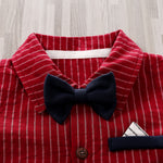 A close-up of the Adorable 1-Piece Striped Infant Clothing Jumpsuit with bow tie and button-up front, showcasing its red and white stripes, navy blue bow tie, and pocket detail on breathable fabric laid on a light wooden surface.