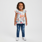 Adorable Toddler Girls Outfit: Floral Peplum Top With Ruffled Sleeves & Denim Jeans Set displayed by a cheerful little girl standing confidently in a floral peplum top and stylish denim jeans.