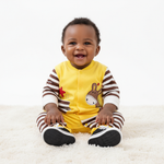 Baby Boy Jumpsuit in Soft Cotton with Giraffe & Star Designs, Snap Closure & Striped Sleeves, showcasing a joyful baby sitting on a soft rug in a playful outfit.