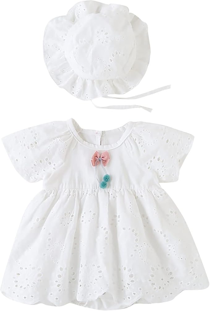 White eyelet baby romper dress and matching hat with a pink and teal bow.