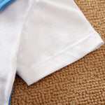 Cozy Baby Blue Romper with Star Print by Hushies - Soft cotton white sleeve detail on woven brown surface close-up