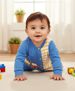 Baby Boy Tiny Builder Jumpsuit, a happy baby crawling on the floor wearing a cute builder themed baby outfit featuring a truck print, ideal for playful adventures.