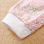 Soft cotton sleeve with pink and brown heart pattern and white cuff with snap.