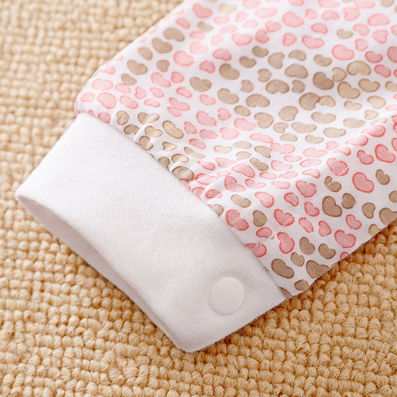 Soft cotton sleeve with pink and brown heart pattern and white cuff with snap.