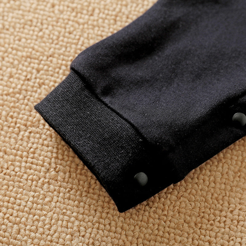 Baby Jumpsuit Nighty Night Hushies - Unisex Soft Cotton close-up of black cuff and snap buttons on infant sleepwear sleeve