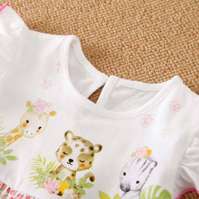 White baby romper with animal prints on a textured surface