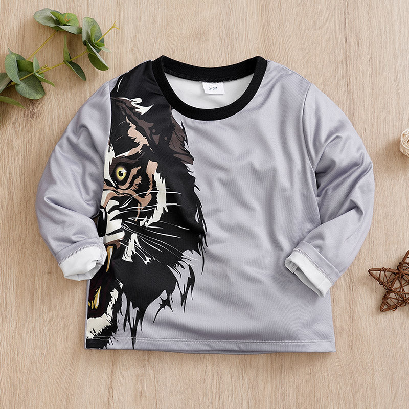 Toddler long-sleeve shirt with a cat graphic on a wooden surface