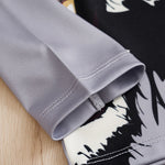 Close-up of a gray fabric edge with a black and white patterned background