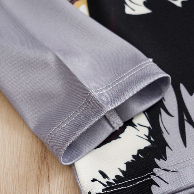 Close-up of a gray fabric edge with a black and white patterned background