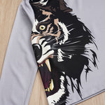 Shirt with a tiger design on a wooden surface