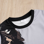 Close-up of a shirt with a black collar and a brand tag on a wooden surface