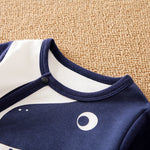Soft Cotton Baby Dinosaur Jumpsuit With Cute Design, Long Sleeve & Easy Snap Closure close-up of navy neckline and snap button on infant romper
