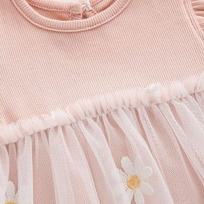 Pink ribbed baby dress with sheer ruffled skirt and white daisy appliques.