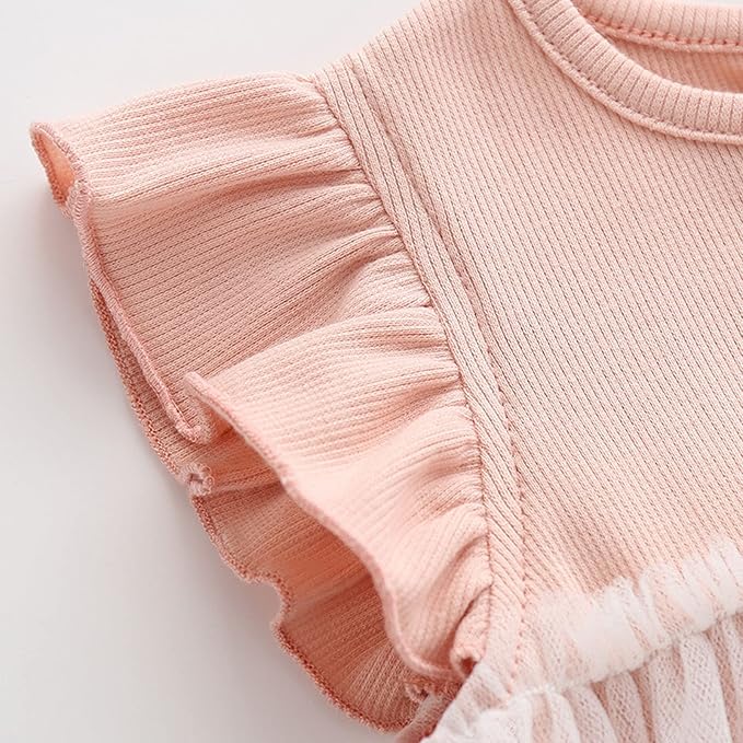 Close-up of a light pink ribbed cotton baby dress with ruffled sleeves.
