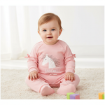 Adorable unicorn baby jumpsuit in soft pink featuring bow details, designed for comfort. Ideal for playdates or cozy days at home.