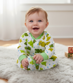 Happy baby seated in a cozy cotton frog star design baby unisex jumpsuit, showcasing playful prints and comfort.