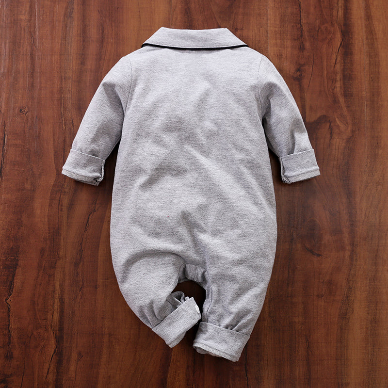 Back view Gray baby cotton pajamas on a wooden surface